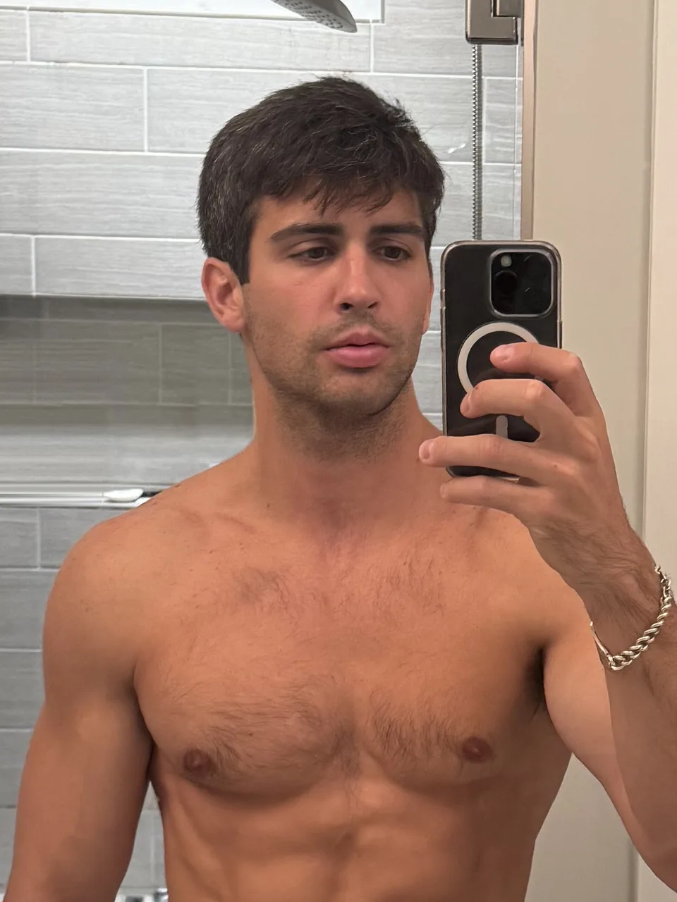 Thomas shirtless taking the same bathroom mirror selfie in week 10 of 75 Hard, visibly leaner